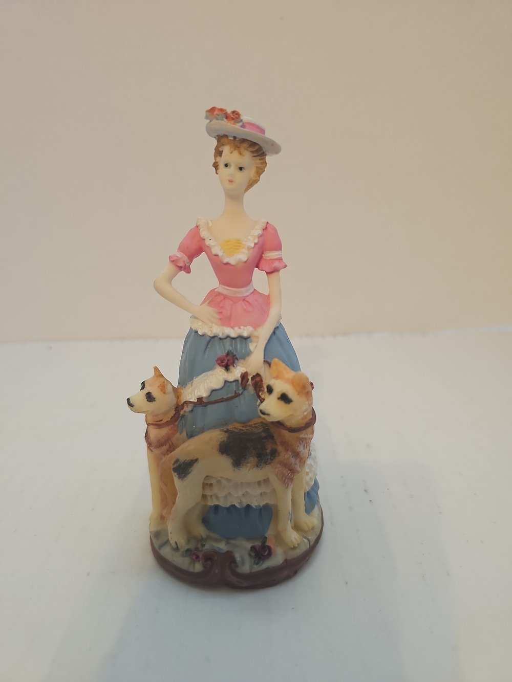 vintage Victorian lady figurine with two dogs. 5"tall